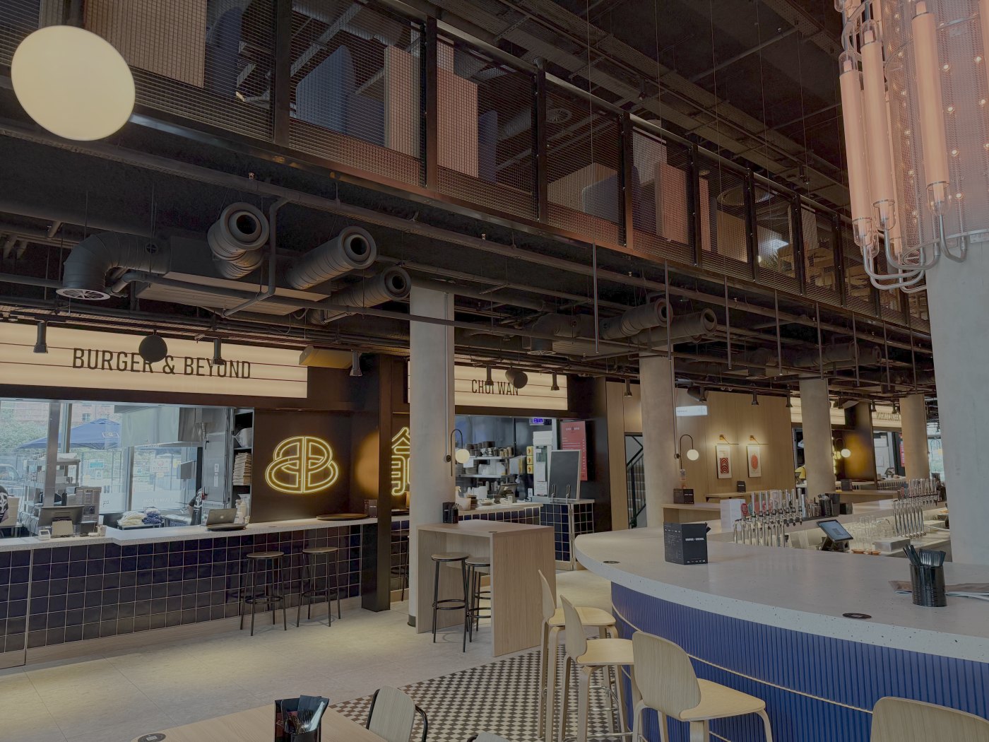 Exposed ductwork and services above the counters of a finished food hall