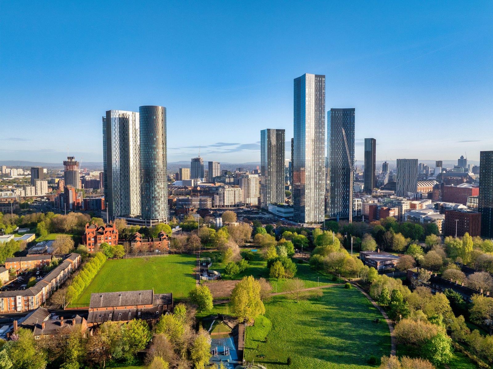 Aerial view of Manchester's residential towers and city skyline on a sunny day