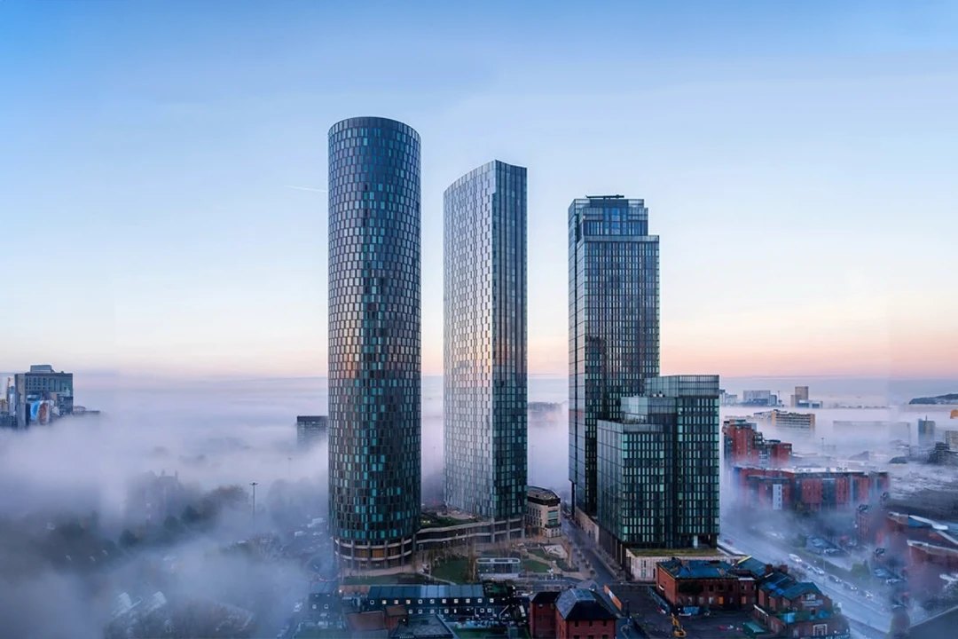 The Circle, The Blade and Elizabeth Towers in Manchester, rising above the morning fog